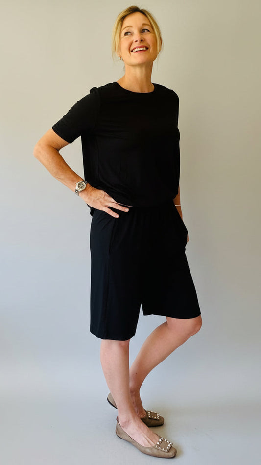 Woman wearing a black shorts with matching top.